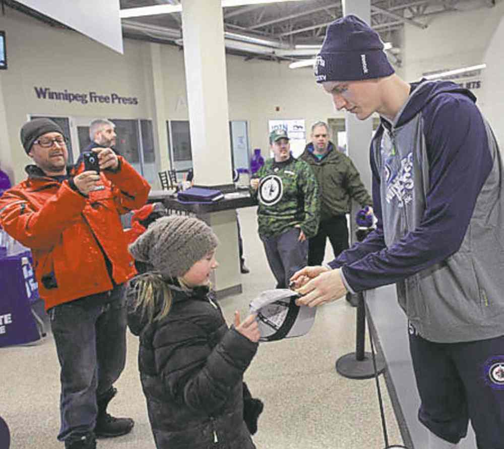 JOE BRYKSA / WINNIPEG FREE PRESS files
JOE BRYKSA / WINNIPEG FREE PRESS files
Tyler Myers signs an autograph for 10-year-old Cleo Wermann Thorn.