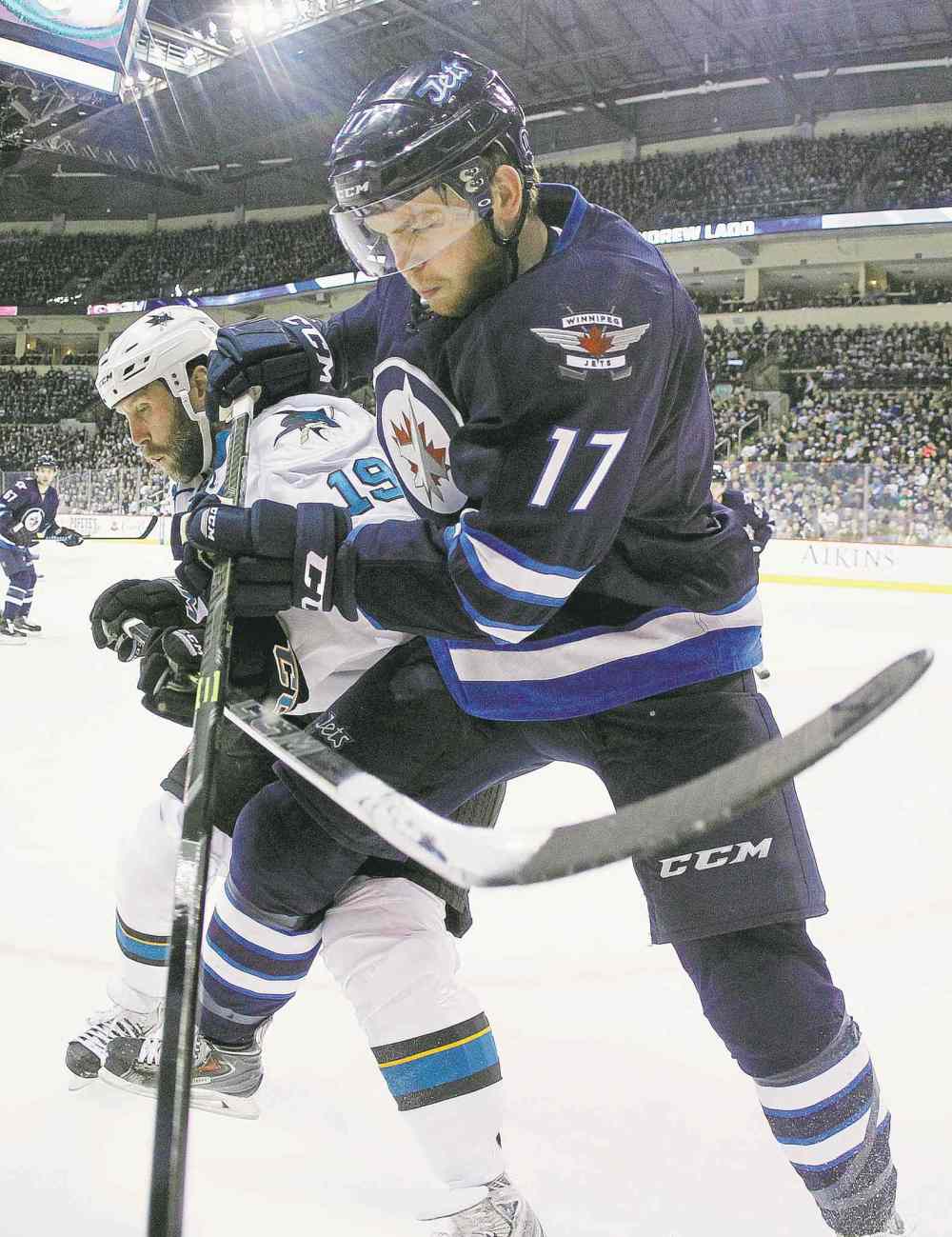 WINNIPEG FREE PRESS
John Woods / WINNIPEG FREE PRESS
Winnipeg�s Adam Lowry battles San Jose�s Joe Thornton for the puck during first-period action Tuesday night.
