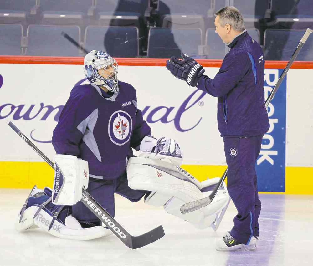 BORIS MINKEVICH / WINNIPEG FREE PRESS
Ondrej Pavelec and goaltending coach Wade Flaherty made time for a strategy session at Wednesday's practice.