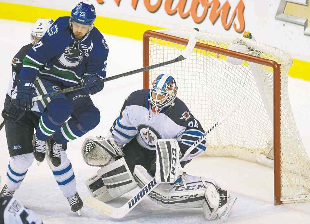 CP
Jonathan Hayward / the canadian press
Vancouver Canucks left-winger Daniel Sedin jumps in front of Winnipeg Jets goalie Michael Hutchinson during Tuesday night�s game at Rogers Centre in Vancouver.