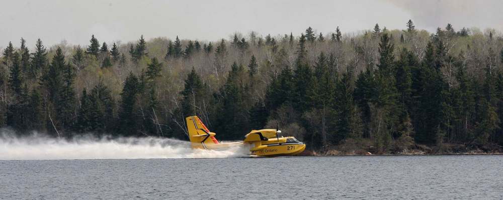 JOE BRYKSA / WINNIPEG FREE PRESS
Water Bombers from Ontario scoop water in Caddy Lake to fight a forest fire near Nora Lake in the Whiteshell Monday.
