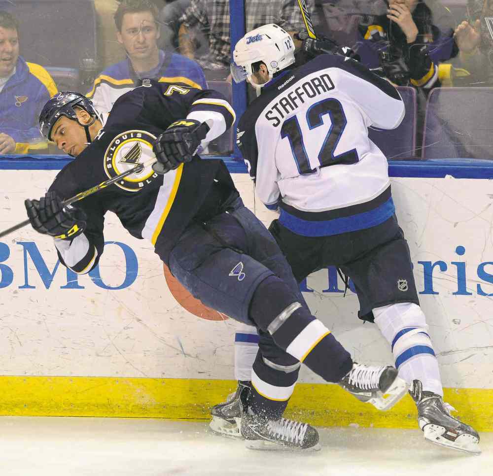 Bill Boyce / The Associated Press
The Blues' Ryan Reeves and the Jets' Drew Stafford collide during the Jets' win in St. Louis Tuesday. Coach Paul Maurice said the reason for a day off was 'all physical.'