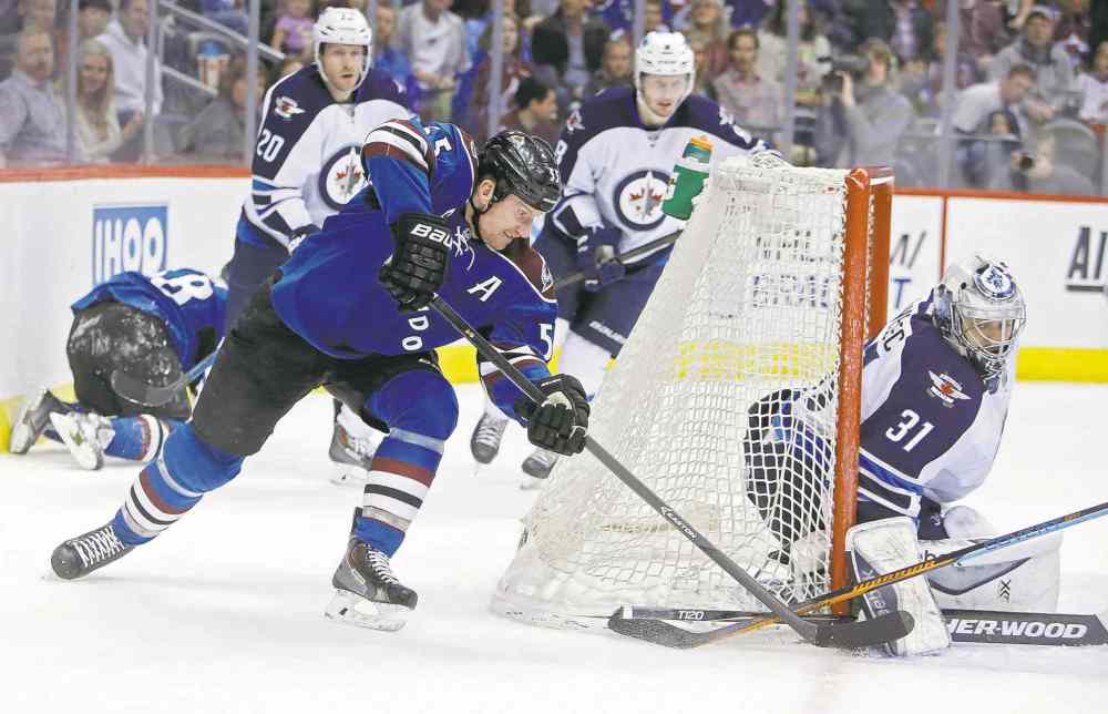 USA Today Sports
Chris Humphreys / USA TODAY Sports
Colorado left-winger Cody McLeod (left) attempts to jam a wraparound attempt past Jets goalie Ondrej Pavelec during second-period action Thursday night.