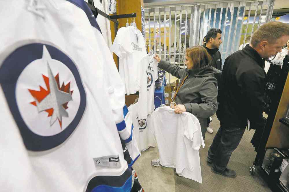 John Woods / THE CANADIAN PRESS
Dez Pope looks for white Jets apparel in the Jets Gear store.