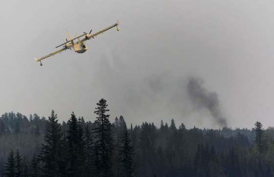 JOE BRYKSA / WINNIPEG FREE PRESSWater bombers were brought in to fight the fire near Nora Lake.