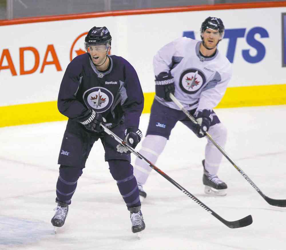 BORIS MINKEVICH / WINNIPEG FREE PRESS
The owner of two Stanley Cup rings, Jets captain Andrew Ladd (left) said after Monday�s workout at the MTS Centre playoff experience is probably overrated.