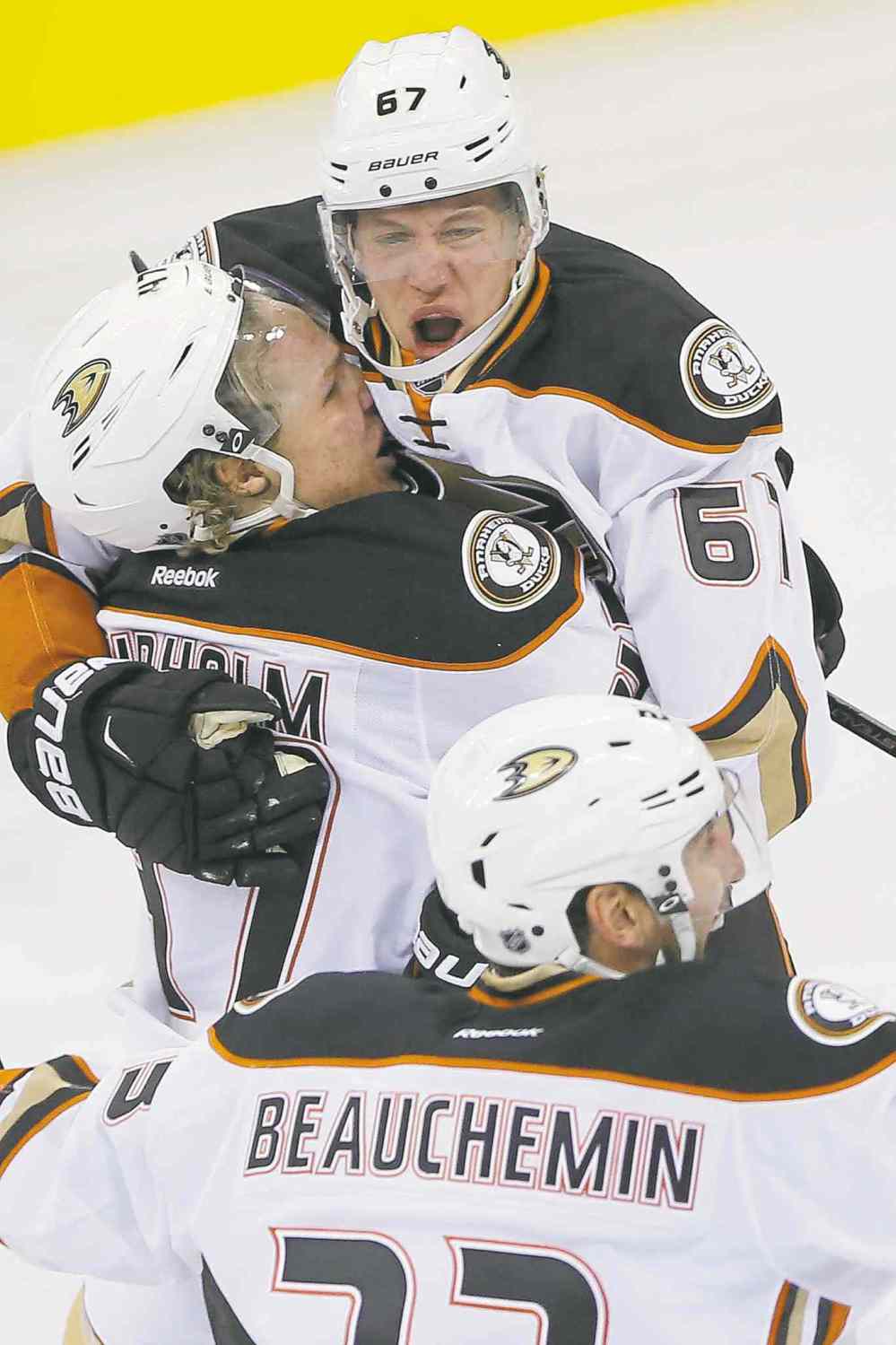 John Woods / Winnipeg Free Press
Anaheim's Rickard Rakell (67), Hampus Lindholm and Francois Beauchemin celebrate Rakell's game-winning goal Monday.