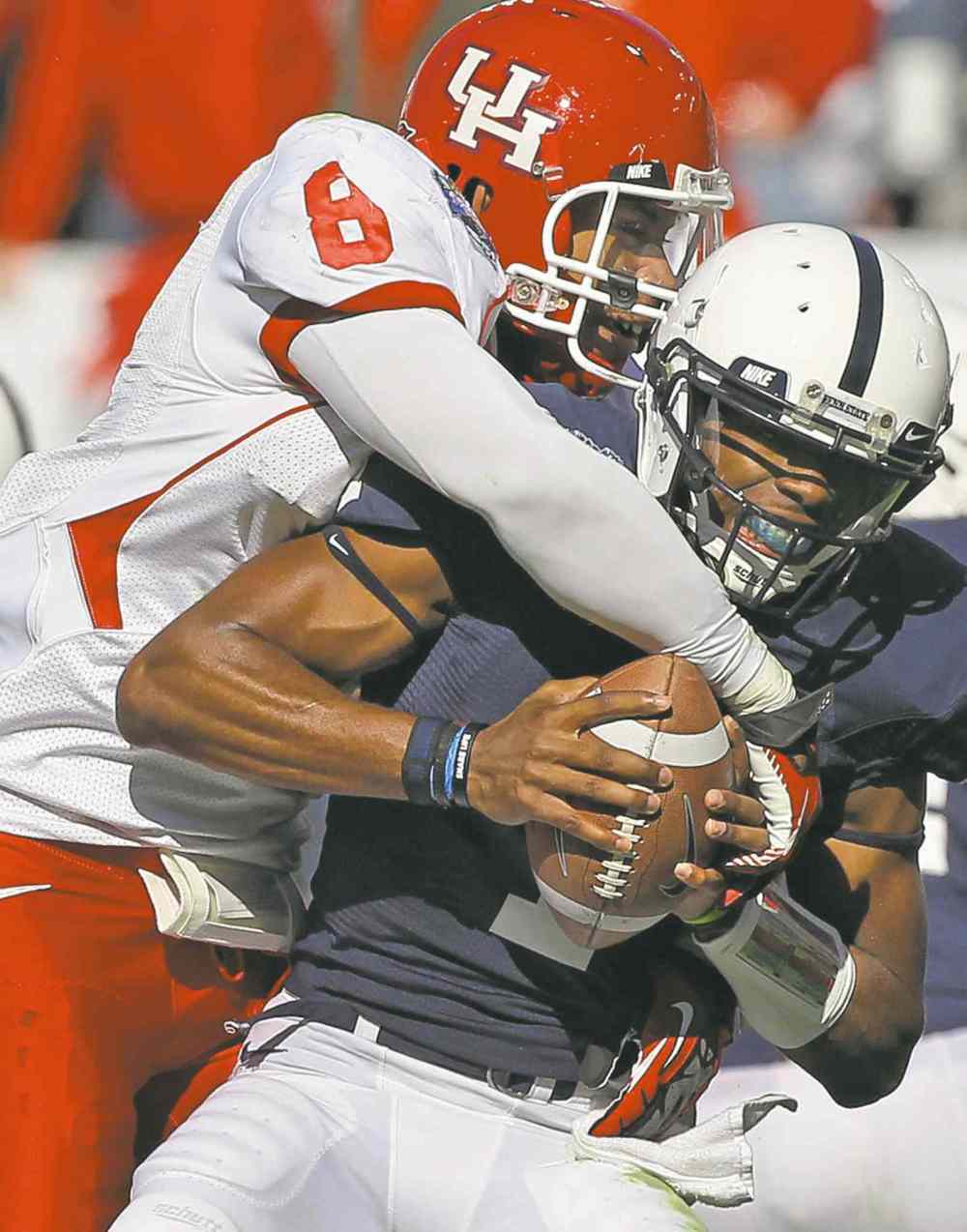 Louis DeLuca / Dallas Morning News / MCT files
Linebacker Sammy Brown puts the wraps on a quarterback during his college days in Houston.