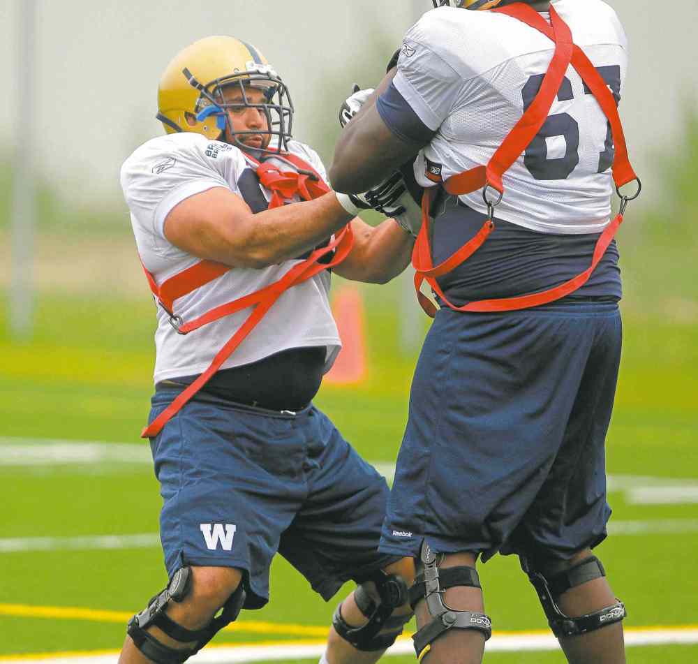 BORIS MINKEVICH / WINNIPEG FREE PRESS
Blue Bombers offensive lineman Sukh Chung (left) is soaking up all the information he can at rookie camp this week.