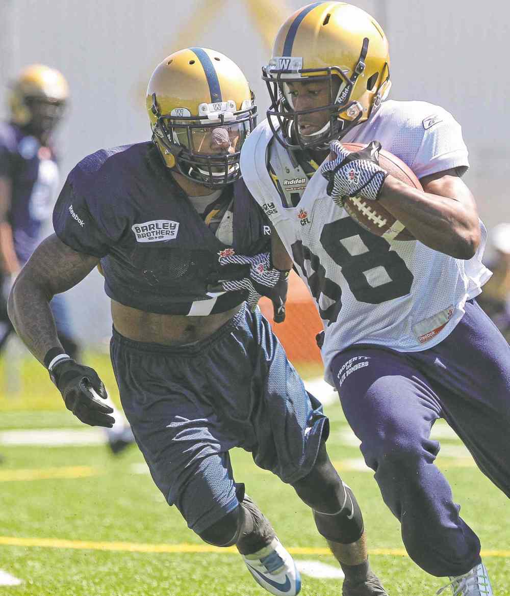 Mike Deal / Winnipeg Free Press
All-round athlete Troy Stoudermire closes in on ball carrier Jhomon Gordon on Day 1 of Winnipeg Blue Bombers training camp on Sunday.