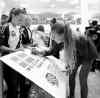 Wayne Glowacki / Winnipeg Free Press
Swedish team member Charlotte Rolhin signs a poster for Jax Correia  of the St. Charles Force after arriving in Winnipeg Wednesday.