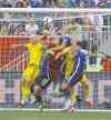 JOE BRYKSA / WINNIPEG FREE PRESSU.S. goaltender Hope Solo (centre) slices through a crowd to punch the ball out of danger after a Swedish corner kick.