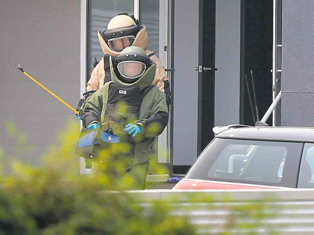 Wayne Glowacki / Winnipeg Free Press
Police bomb-unit members leave a law office on River Avenue Friday. Lawyer Maria Mitousis opened a package and a bomb exploded.
