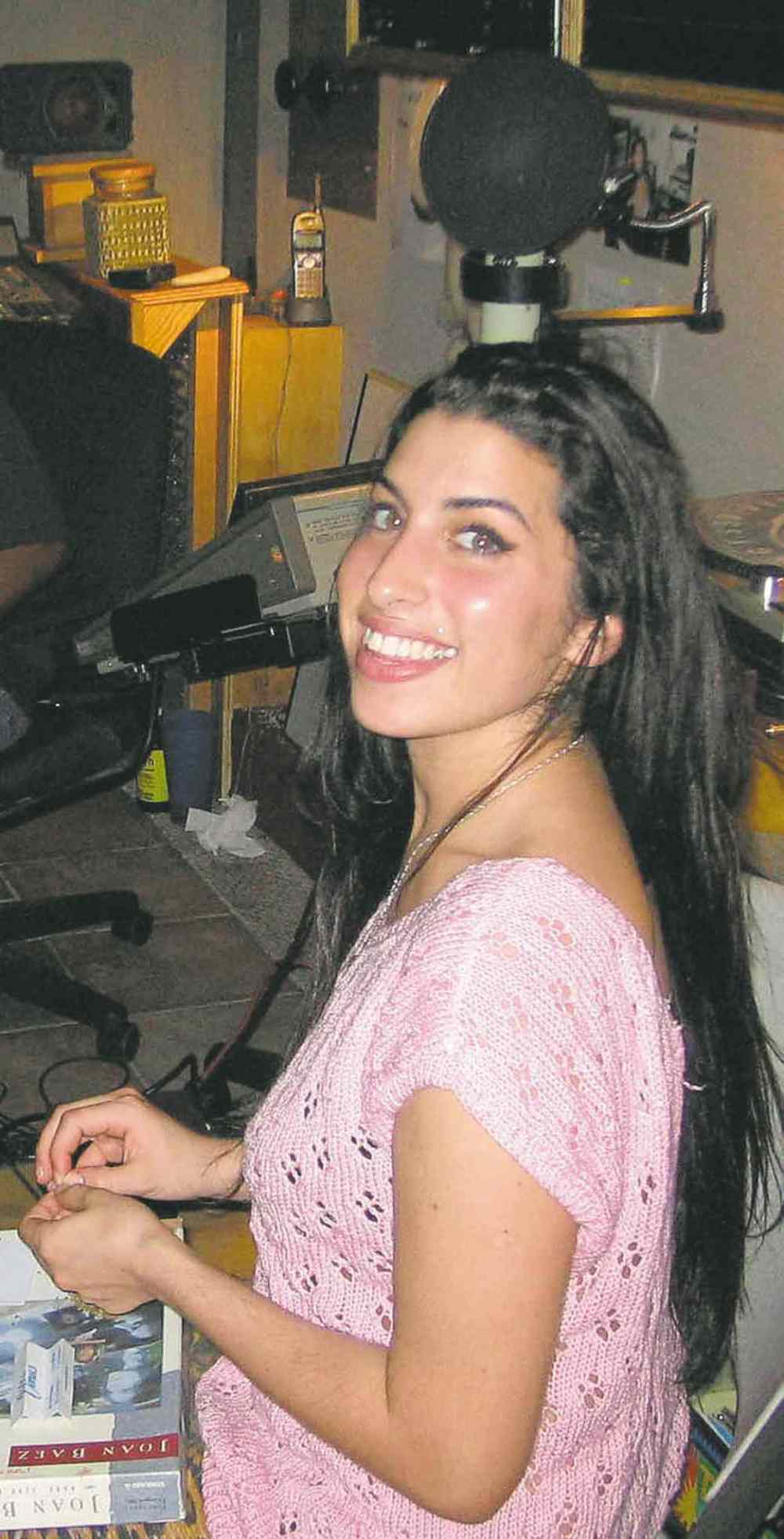 A fresh-faced Amy Winehouse, looking unlike a rock star.