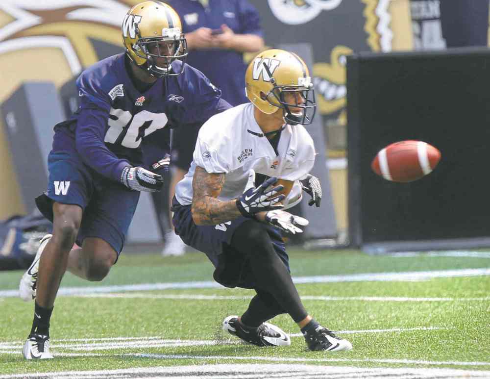 Wayne Glowacki / Winnipeg Free Press files
If Nick Moore (right) keeps catching balls at his current pace, he'll break the CFL record for receptions in a season set in 1983 by Toronto's Terry Greer.