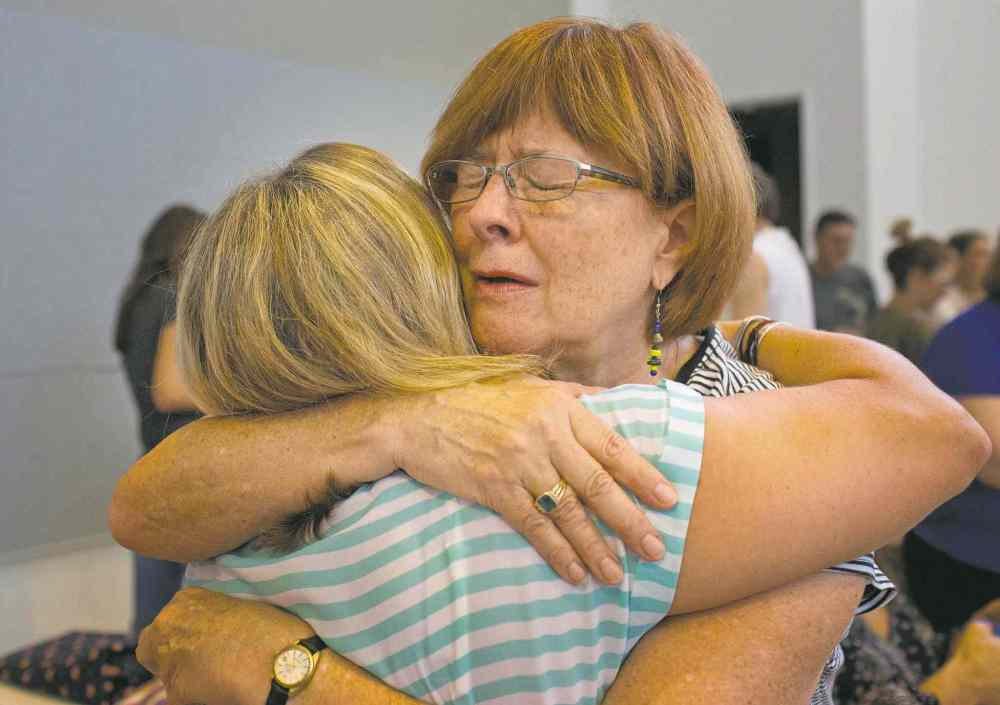CP
BRYNN ANDERSON / THE ASSOCIATED PRESS
Jill Broussard (left) hugs Renee Roberts Saturday during a memorial for the victims of a deadly shooting at a movie theatre in Lafayette, La.