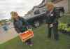 Daniel Blaikie places a campaign sign on a Transcona lawn Wednesday evening, assisted by Breigh Kusmack. 
Phil Hossack / Winnipeg Free Press
