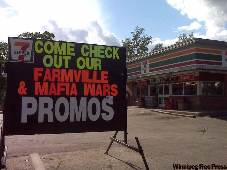 Gabrielle Giroday / The Winnipeg Free Press
A sign outside a 7-Eleven store, in the same neighbourhood where two children were injured in a gang shooting, promotes the online Mafia Wars game.