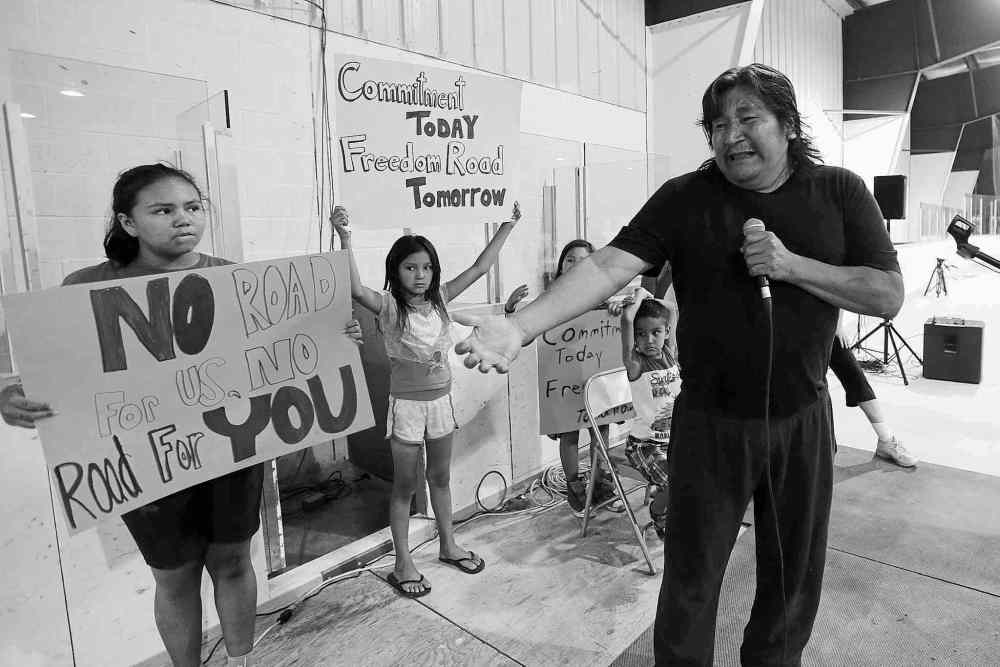 CP
John Woods / THE CANADIAN PRESS files
ABOVE: Stewart Redsky weeps while his children hold signs demanding a road to Shoal Lake No. 40 First Nation in June after visiting Natural Resources Minister Greg Rickford declined to commit to the full project.