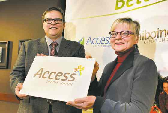 Boris Minkevich / Winnipeg Free Press FilesAccess Credit Union board chairman Darryl Loewen and Margaret Day of Assiniboine Credit Union were all smiles in February, when the merger was first announced. The members' vote in April, however, quashed the plan.