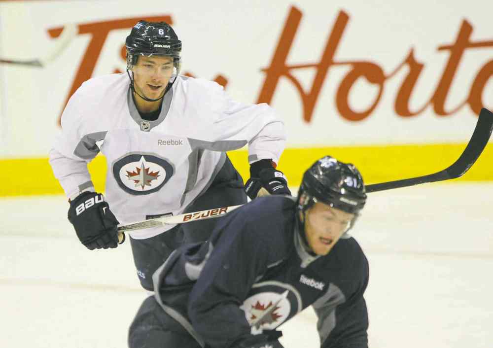 joe bryksa / winnipeg free press
Alexander Burmistrov (rear) predicts a fun season, what with the team being so young. He also predicts a good season.