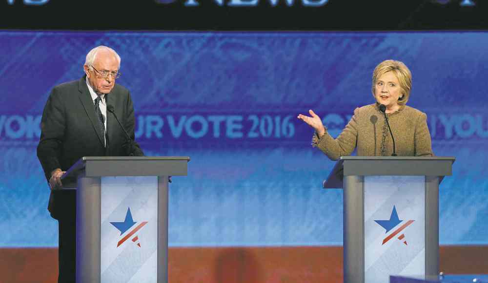 CP
JIM COLE / THE ASSOCIATED PRESS
Sen. Bernie Sanders listens as Hillary Clinton speaks during a Democratic presidential primary debate Saturday in Manchester, N.H.