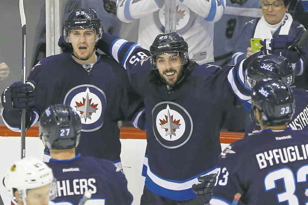 CP
john woods / the canadian press files
Mathieu Perreault (centre) celebrates a goal against the Chicago Blackhawks in a 3-1 Jets win Oct. 29.