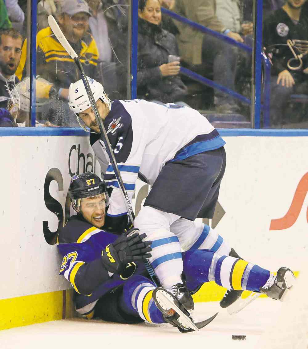 CP
chris lee / st. louis dispatch-post files
Winnipeg Jets defenceman Mark Stuart (top) played though his injury Saturday, but will now be out four to six weeks.