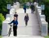 PHIL HOSSACK / WINNIPEG FREE PRESS
Sylvie Roy, walking her bike across the Assiniboine Park pedestrian bridge, says helmets are a good idea but she hasn't found one she likes.