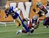 PHIL HOSSACK / WINNIPEG FREE PRESS
Winnipeg running back Andrew Harris surges past Montreal defender Jovon Johnson (2) and Chris Ackie during Wednesday’s action at Investors Group Field.