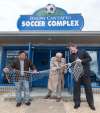 photos by MIKE DEAL / WINNIPEG FREE PRESS
Ralph Cantafio Sr. prepares to cut a soccer net to officially rename the Winnipeg Waverley Soccer Complex to the Ralph Cantafio Soccer Complex in his honour Sunday morning. He is flanked by Winnipeg City Councillor Mike Pagtakhan (left) and Matthew Duffy with the Winnipeg Soccer Federation.