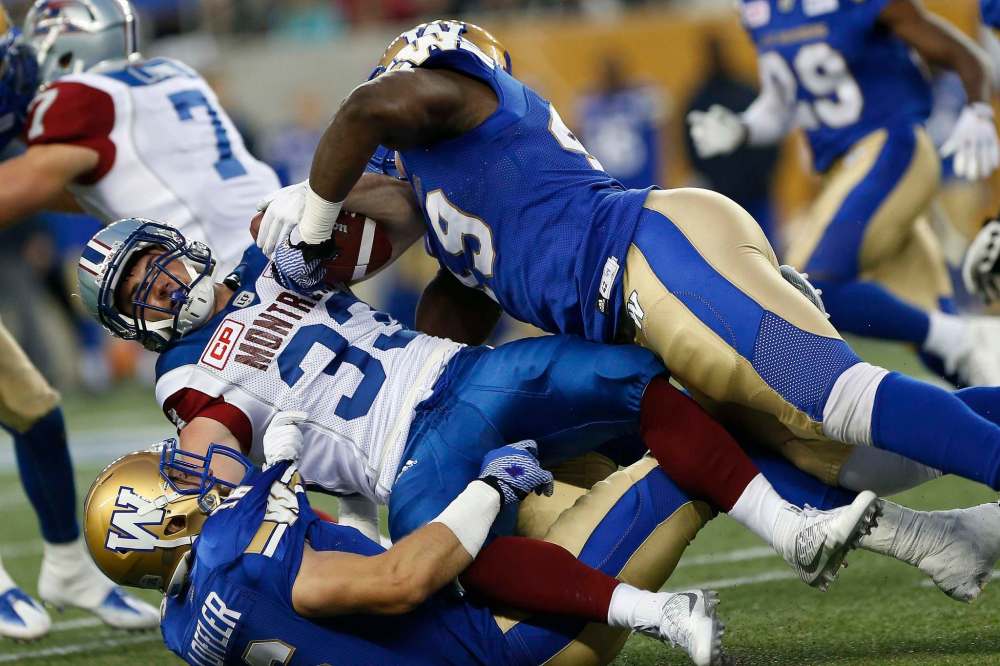 JOHN WOODS / THE CANADIAN PRESS FILES
Winnipeg Blue Bombers' Taylor Loffler (16) and Shayon Green (49) take down Montreal Alouettes' Cam McDaniel (33) during the second half of pre-season CFL action in Winnipeg Wednesday, June 8, 2016.