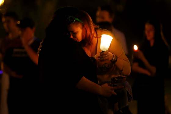 JOHN WOODS / WINNIPEG FREE PRESSPeople comfort each other at a vigil for Orlando shooting victims at the Manitoba legislature Monday evening.