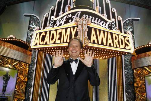 Chris Carlson/ The Associated Press
Billy Crystal pauses for a picture showing nine fingers for the number of times he's hosted the show after the 84th Academy Awards on Sunday, Feb. 26, 2012.
