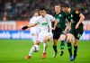 Wolfsburg's Yannick Gerhardt, center, and Augsburg's Ja-Cheol Koo, left, challenge for the ball during the German Bundeliga soccer match between FC Augsburg and VfL Wolfsburg in Augsburg, Germany, Sunday, Dec. 23, 2018. (Tobias Hase/dpa via AP)