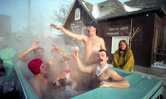 Fans enjoy a ride in a hot tub before the Grey Cup Parade. Geez, remember old Tokyo Joe's on Pioneer (now William Stephenson Way)? Also: does anyone else feel bad for the chilly-looking lady behind the hot tub?  Make some room, dudes!  November 23, 1991.Marc Gallant / Winnipeg Free Press