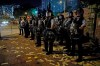 Riot police stand guard during a demonstration that coincided with the ghost festival, a traditional local observance marked by the belief that the gates of hell will open for the month and ghosts would roam the streets, in Hong Kong on Friday, Aug. 9, 2019. Hong Kong leader Carrie Lam said Friday her priority is to 