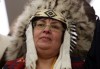 Fred Chartrand / The Canadian Press
Attawapiskat Chief Theresa Spence, wearing a headdress, takes part in a drum ceremony before departing a Ottawa hotel to attend a ceremonial meeting at Rideau Hall with Gov. Gen. David Johnston in Ottawa, Friday.