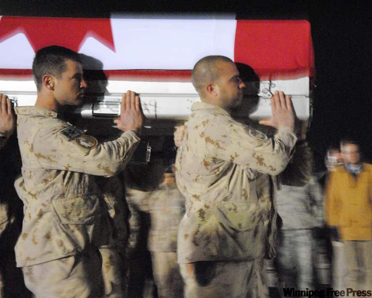 Steve Rennie / The Associated Press
Military pallbearers carry the casket of Cpl. Steve Martin Sunday during the ramp ceremony at Kandahar Airfield in Afghanistan.