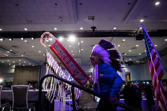 CPAssembly of First Nations National Chief Perry Bellegrade carries the eagle staff as he walks onto the stage for the opening of the AFN Annual General Assembly, in Vancouver on Tuesday, July 24, 2018. THE CANADIAN PRESS/Darryl Dyck