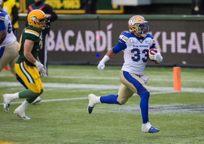 AMBER BRACKEN / THE CANADIAN PRESS
Winnipeg Blue Bombers' Andrew Harris (33) runs in a touchdown ahead of Edmonton Eskimos' Adam Konar (38) during first half CFL action in Edmonton, Alta., on Saturday September 29, 2018.