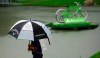 A golfer heads inside to shelter as play is suspended due to weather during the final round of the Regions Tradition Champions Tour golf tournament, Sunday, May 12, 2019, in Birmingham, Ala. (AP Photo/Butch Dill)