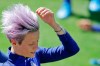 United States' Megan Rapinoe adjusts her hair before the start of a training session at the Gymnase Parc des Sports in Limonest, outside Lyon, France, a day before their Women's World Cup final match against the Netherlands, Saturday, July 6, 2019. (AP Photo/Alessandra Tarantino)