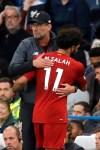Liverpool's manager Jurgen Klopp, left, hugs Liverpool's Mohamed Salah as he leaves the pitch during the British premier League soccer match between Chelsea and Liverpool, at the Stamford Bridge Stadium, London, Sunday, Sept. 22, 2019. (AP Photo/Matt Dunham)