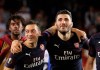 FILE - In this Thursday, May 9, 2019 file photo, Arsenal defender Sead Kolasinac, right celebrates with Arsenal midfielder Mesut Ozil, left, at the end of the Europa League semifinal soccer match, second leg, between Valencia and Arsenal at the Camp de Mestalla stadium in Valencia, Spain. Arsenal says Mesut Ozil and Sead Kolasinac will not be in the squad for its Premier League season opener due to police investigating “security incidents” two weeks after they fought off two knife-wielding men, it was reported on Friday, Aug. 9, 2019. (AP Photo/Alberto Saiz, File)