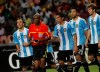 FILE - In this Wednesday, June 1, 2011 file photo, referee Ibrahim Chaibou, second left, is surrounded by Argentina soccer players after he awarded a penalty against them during an international friendly soccer match with Nigeria Super eagles at the National stadium in Abuja, Nigeria. An international soccer referee who has long been implicated in fixing matches has been banned for life for taking bribes, it was reported on Thursday, Jan. 24, 2019. FIFA says its ethics committee judges found Ibrahim Chaibou guilty of taking bribes and also fined him 200,000 Swiss francs ($201,000). (AP Photo/Sunday Alamba, file)