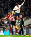 Sheffield United's Chris Basham, left and Tottenham Hotspur's Dele Alli battle for the ball, during the English Premier League soccer match between Tottenham Hotspur and Sheffield United, at Tottenham Hotspur Stadium, in London, Saturday, Nov. 9, 2019. (Bradley Collyer/PA via AP)