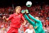 Berlin's Sebastian Andersson, left, vies for the ball with Leipzig goalkeeper Peter Gulacsi, during the German Bundesliga soccer match between Union Berlin and RB Leipzig, at the Stadion An der Alten Foersterei, in Berlin, Sunday, Aug. 18, 2019. (Andreas Gora/dpa via AP)