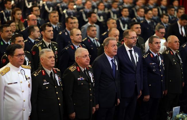 Turkey's Defense Minister Hulusi Akar, front center, flanked by Turkish army's top commanders before he speak at the National Defence University, in Istanbul, Wednesday, Oct. 9, 2019. Akar says preparations for an expected Turkish incursion into Syria are continuing. (Turkish Defense Ministry via AP, Pool)