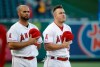 Los Angeles Angels' Albert Pujols, left, and Mike Trout listen to the national anthem before the team's baseball game against the Oakland Athletics on Friday, June 28, 2019, in Anaheim, Calif. (AP Photo/Marcio Jose Sanchez)